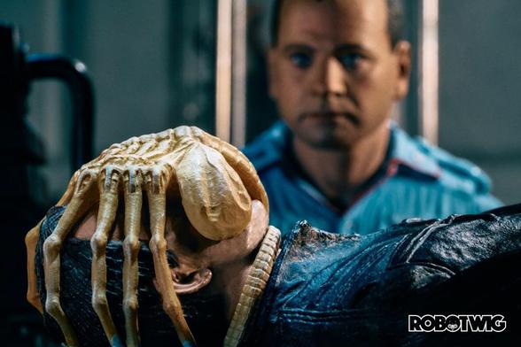 Ash looks on at a Facehugger wrapped around Kanes face