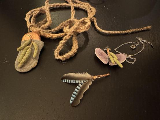Three handmade amulets made of foraged material.