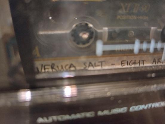 Photo of a cassette player playing a cassette that says "VERUCA SALT - EIGHT AR".