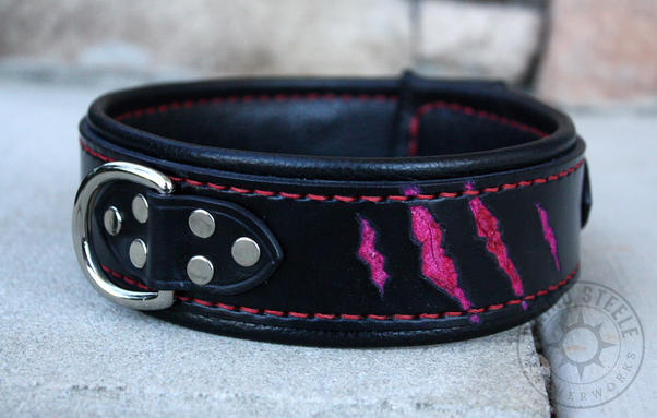 A solid black leather collar with red clawmarks, red stitching, and nickel hardware