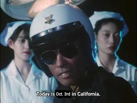 ID: Edited Super Sentai screenshot. A cop surrounded by nurses sits up and says, "Today is October 3rd in California." /end ID