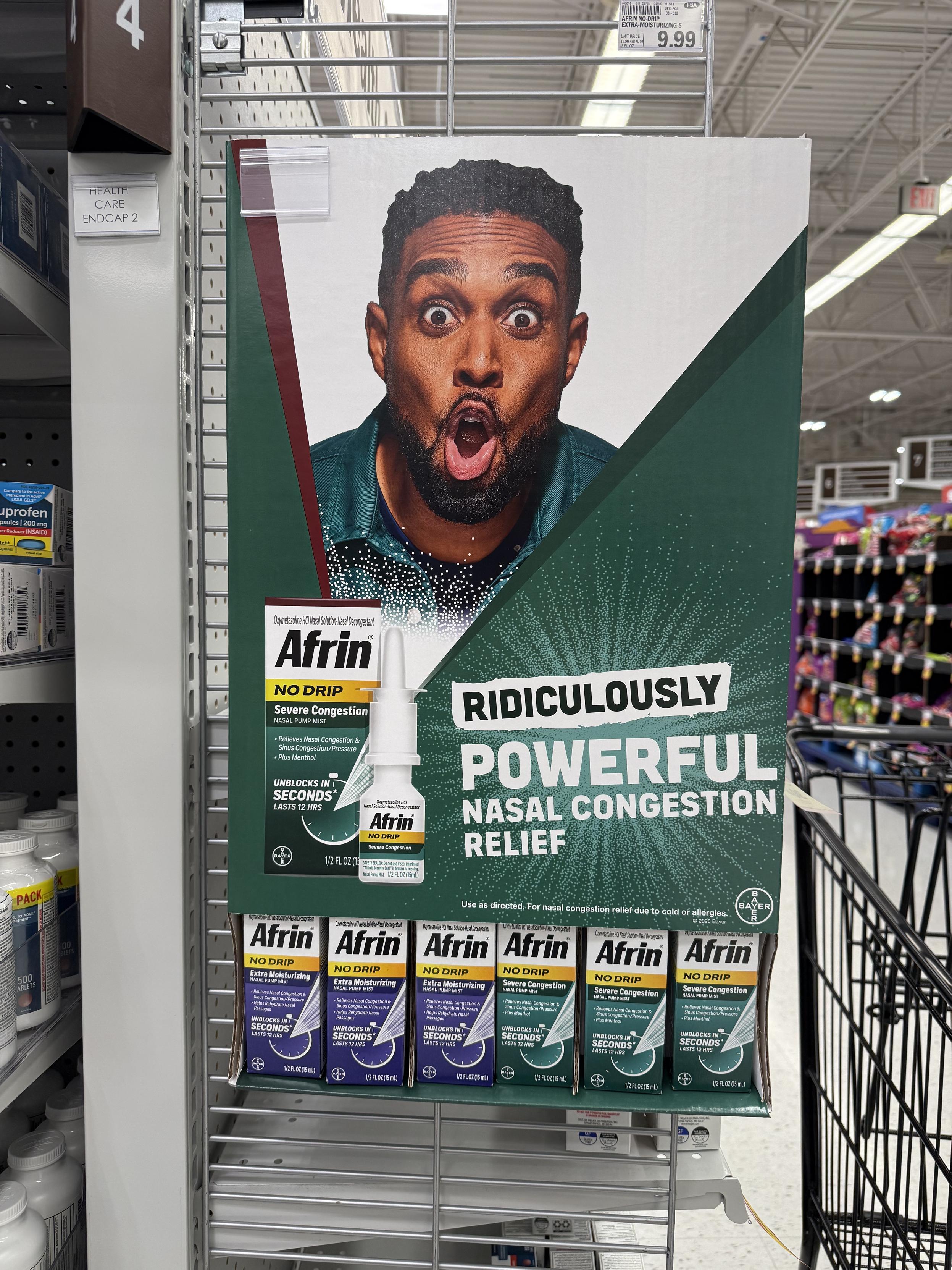 A store display for Afrin nasal spray featuring a man making an exaggerated facial expression