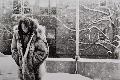 Neil in a full length fur coat on a snowy winters day in Canada.