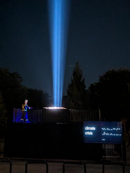 A beam of light being used to transmit "#woke" words banned or suppressed by the current US President condemning censorship