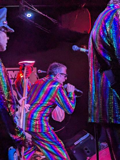 A photo of the Sea Monkeys at Monty Hall, shot from the side of the stage and zoomed in on singer Dave The Spazz.