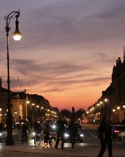 night long exposure of the light illuminating a street with bikes and cars passing