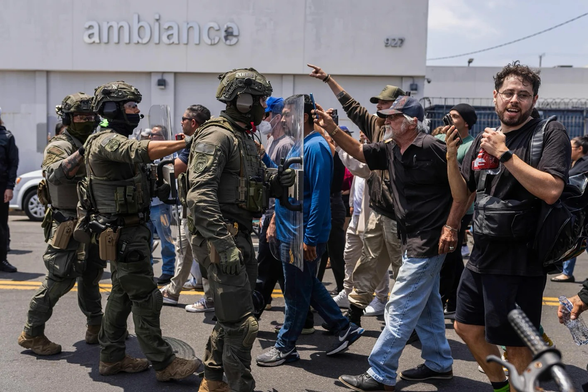 Federal immigration authorities face off against protesters during an ICE raid at Ambiance Apparel in Downtown Los Angeles on June 6, 2025. | Photo by J.W. Hendricks for CalMatters. Photo shows protesters standing up to ICE. Good on them.