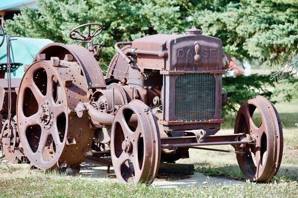 A very old, rusted steel tractor/thresher build by the J.I. Case Threshing Machine Co. Vintage unknown by the photographer.