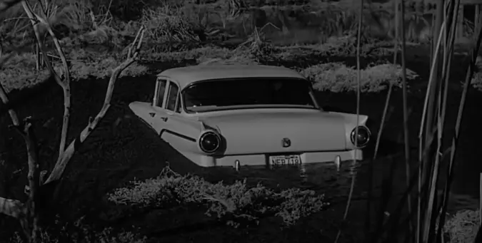 Black & White still of a white car sinking into the mud. From Psycho by Alfred Hitchcock.