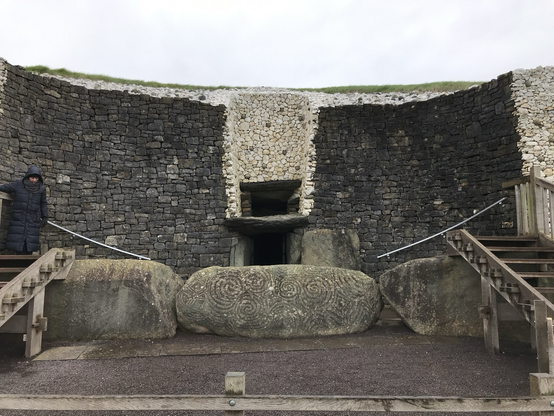 Colour shit of the entrance to Newgrange.  Three large stones on their sides.