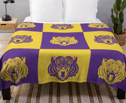 Our purple and gold tiger design is shown on a throw blanket.