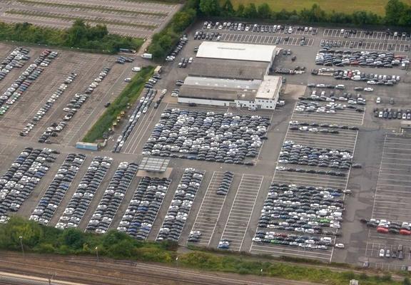 Imatge aèria d'un aparcament amb centenars de cotxes aparcats.