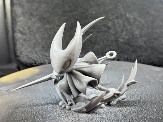 A 3d printed model of Hornet from Hollow Knight Silksong. It’s in the raw grey resin before priming. Shown from the front slightly off to the right.