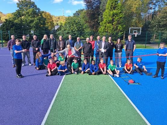 Council leader John Spanswick, Cabinet Member Cllr Paul Davies, Mayor Gavin Thomas, Jack Sargeant MS and Stephen Kinnock MP join pupils from St Mary’s & St Patrick’s RC Primary School at the official reopening of refurbished netball and basketball courts in Maesteg.