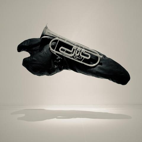 A gallery item: a silver trumpet hanging on a black cloud