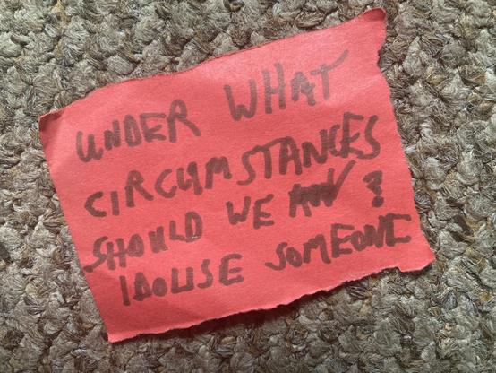 Small red card with ‘under what circumstances should we idolise someone?’ handwritten on it