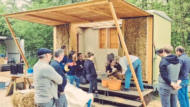 folks learning to bulld with straw, timber and earth at our mobile construction site