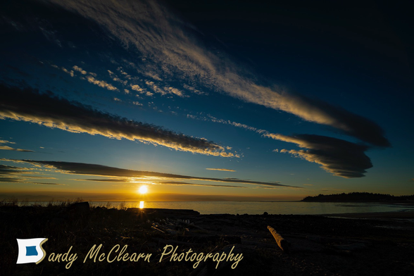 Clouds in the sky over sunrise at a beach.