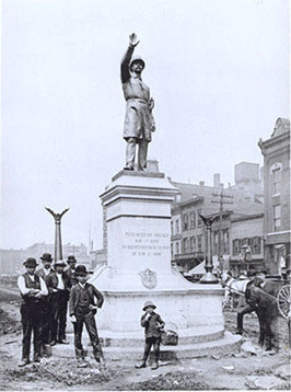 Workers finish installing Gelert's statue of a Chicago policeman in Haymarket Square, 1889. The statue was destroyed by a bomb in 1969 and a replica now stands at the Chicago Police Headquarters. By A[dolph]. Witteman - Chicago Historical Society (ICHi-14452) http://www.encyclopedia.chicagohistory.org/pages/3774.html, Public Domain, https://commons.wikimedia.org/w/index.php?curid=3424497