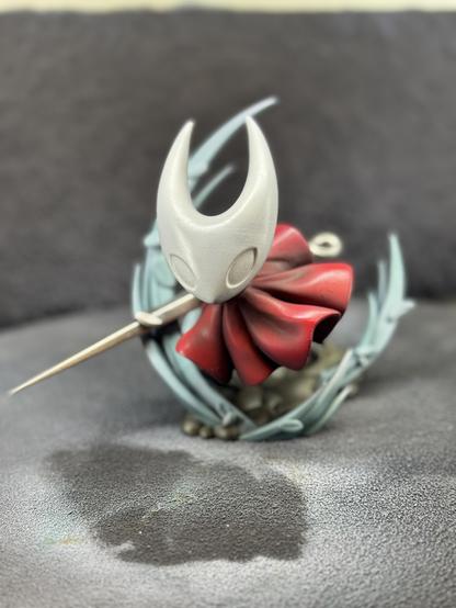 A 3d printed figure of Hornet from the game Hollow Knight Silksong. After airbrushing more shading and colors. The model is shown from the front.
