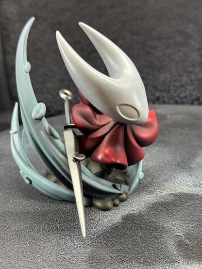 A 3d printed figure of Hornet from the game Hollow Knight Silksong. After airbrushing more shading and colors. The model is shown from closer and the left.