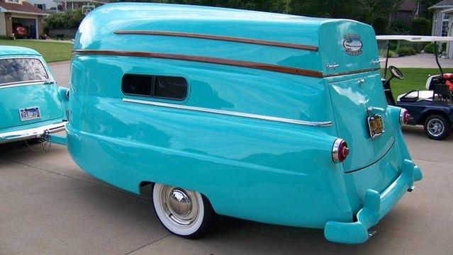 1954 camper with a boat as its top.