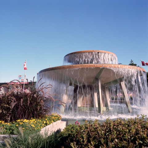 A fountain in the sun with slow slow shutter speed motion blur in the cascades of water.