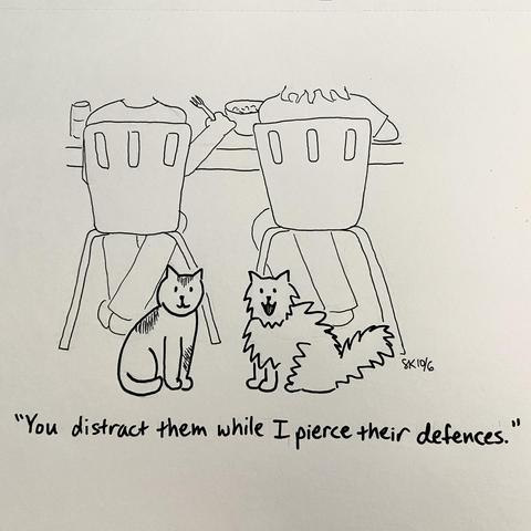 A drawing of two cats sitting on the floor next to two people eating at a kitchen table. One cat says to the other, “you distract them while I pierced their defenses.”