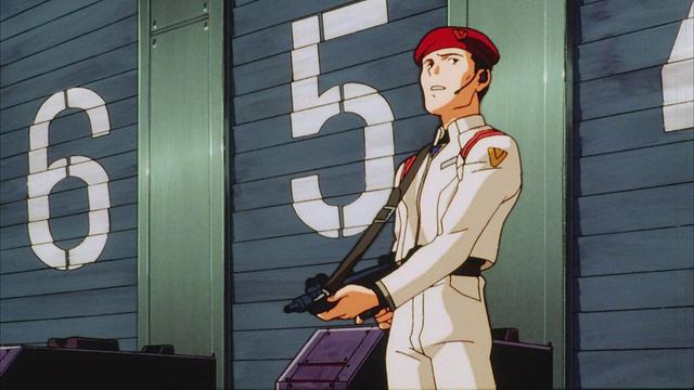 Scene from The End of Evangelion:

NERV security guard in alert with his back toward the big doors, at the beginning of the final siege.