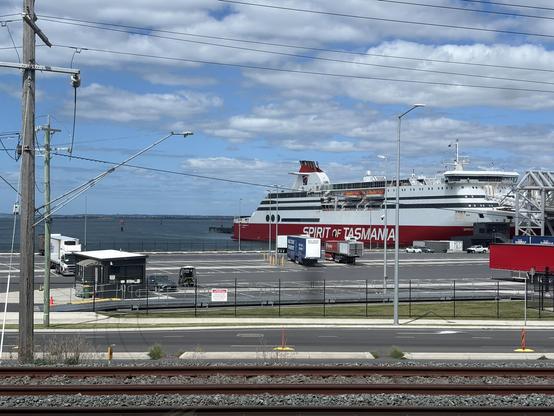 Big red and white ferry at dock.