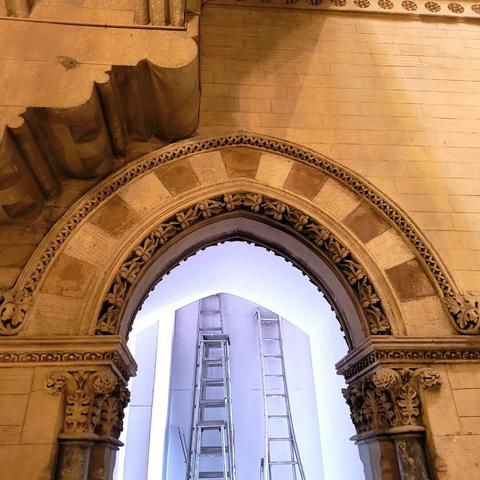 Arched entrance into a room undergoing renovations