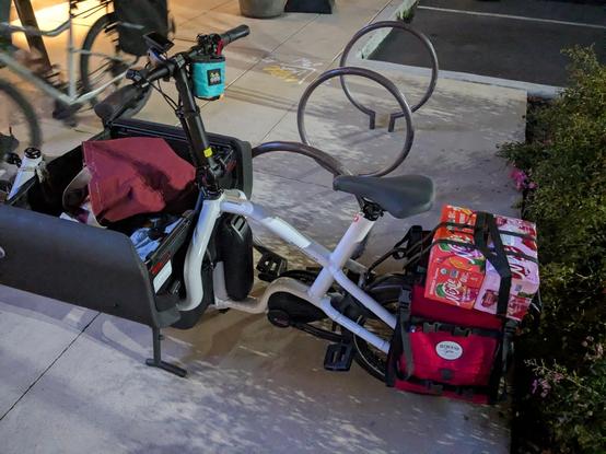 The Cargo Demon, a newfangled convertible bakfiets, has two racks of seltzer strapped to the rear rack and four very full cloth grocery bags stuffed in the front box. The front box will not close, so we're going home with it locked open, as god intended