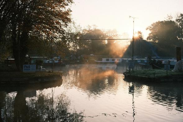 Foggy entrance to a marina bathed in golden light.