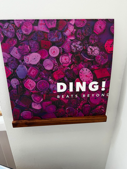 Record cover Ding! Beats Beyond, beet colored photo of a pile of watches
