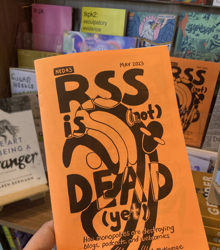 An orange zine cover that says RSS is (not) dead (yet): how monopolies are destroying blogs, podcasts, and webcomics