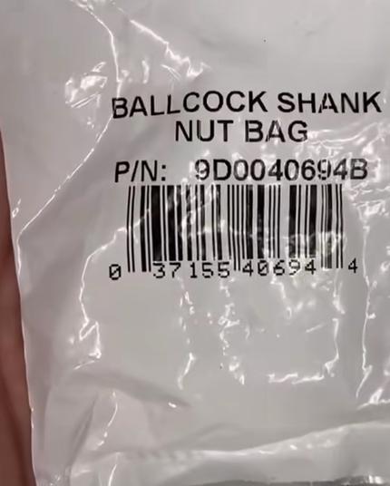 Photo of a white plastic bag with a UPC bar code. The text of the product name reads “BALLCOCK SHANK NUT BAG.”