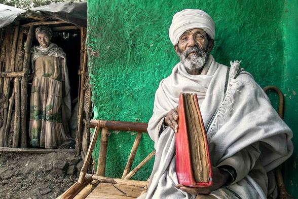 Orthodox priest with a holy book written in geʽez alphabet (Ethiopia).

Geʽez, sometimes referred to in scholarly literature as Classical Ethiopic, is an ancient Ethiopian language.
The language originates from what is now northern Ethiopia and Eritrea.
Today, geʽez is used only in prayer and in scheduled public celebrations as the liturgical language of the Ethiopian and Eritrean Orthodox and Catholic Church.
Ge‘ez already disappeared as a spoken language almost 1 thousand years ago.
Nowadays even the written language is going to disappear since fewer and fewer people are able to read and write this language and the new generations are less and less interested in learning it.

Website: <a href="https://robertopazziphoto.com/" rel="noreferrer nofollow">robertopazziphoto.com/</a>

Instagram: <a href="https://www.instagram.com/roberto_pazzi_photo/" rel="noreferrer nofollow">www.instagram.com/roberto_pazzi_photo/</a>