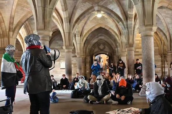 Students hold a sit in to mark the second anniversary of the genocide
