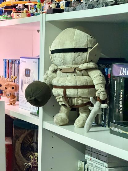 Plush of Siegmeyer. He wears a big bulky helmet with a slit to look out of, making it look like he’s wearing an onion.