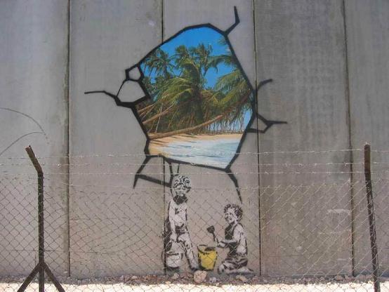 Image of a big gray wall with a painting of two children and black and white with sand buckets one bucket is yellow and there is above them a window that is cracked full of color and blue if it was the sea with palm trees