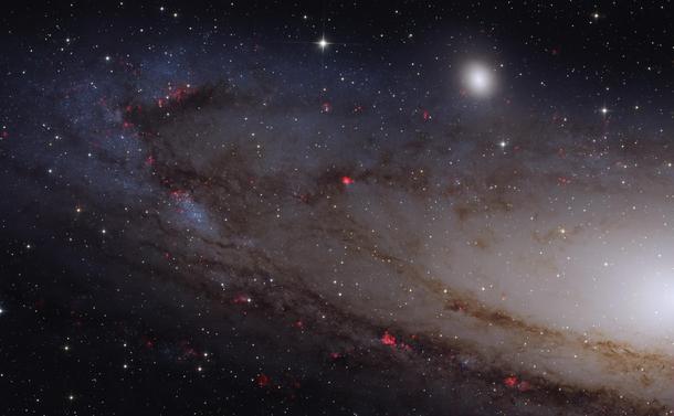 Astrophoto off our nearby Andromeda galaxy with active regions highlighted in red.