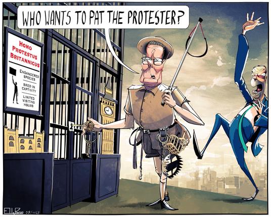 Starmer stands by a cage, wearing a pith helmet. Farage cheers in the background.
A sign on the cage suggests they are an endangered species