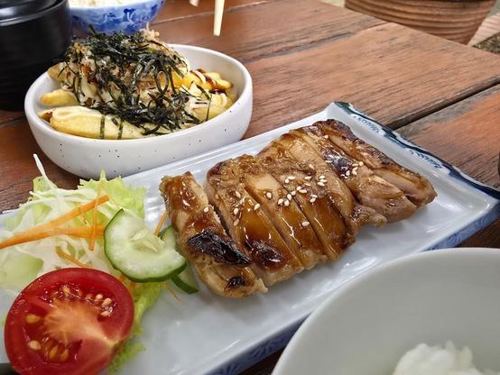 Japanese meal with teriyaki chicken, salad, and loaded fries.