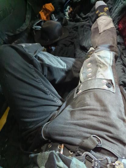 Showing most of the front of the pants. Never mind the denim folds and creases... Two front pockets plus a pleather cover up near the bottom right leg