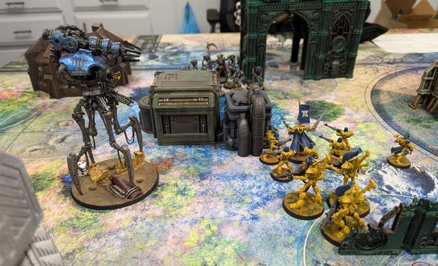 A miniature wargame in progress. The robots advance on the space elves.