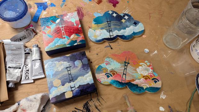4 small paintings featuring Sutro Tower. Two are square and two are cloud-shaped. They are all brightly colored with clouds and geometric patterns.
