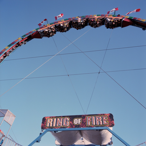 The Ring Of Fire takes its riders on a 360 loop against a clear blue sky.