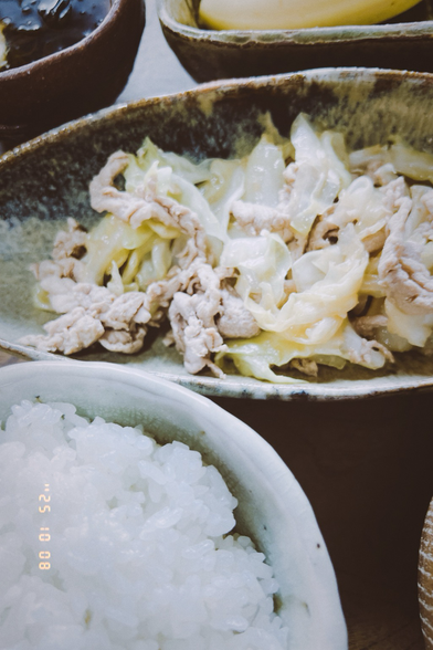 The pork dish, a cup of rice and a cup of miso soup.