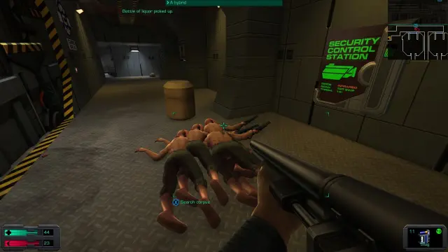 Screenshot of system shock 2, showing a number of dead hybrids infront of a hacked turret