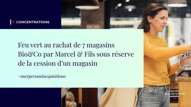 A woman with shoulder-length hair wearing a yellow sweater and jeans stands in a brightly lit supermarket aisle, holding a woven basket and examining a product on the shelf. The background shows shelves stocked with jars and bottles, another person in the distance, and a blue sign with white text. Overlay text in French reads Feu vert au rachat de 7 magasins Bio&Co par Marcel & Fils sous réserve de la cession d'un de ces magasins à un concurrent, with hashtags mergers and acquisitions. The Autorité de la Concurrence logo appears in the top left corner.